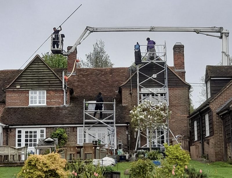 The Moss Cleaners using cherry picker and scaffolding to clean roof safely and professionally in 29 Cleveland Rd, New Malden KT3 3QQ, UK, 29 Cleveland Rd, New Malden KT3 3QQ, UK